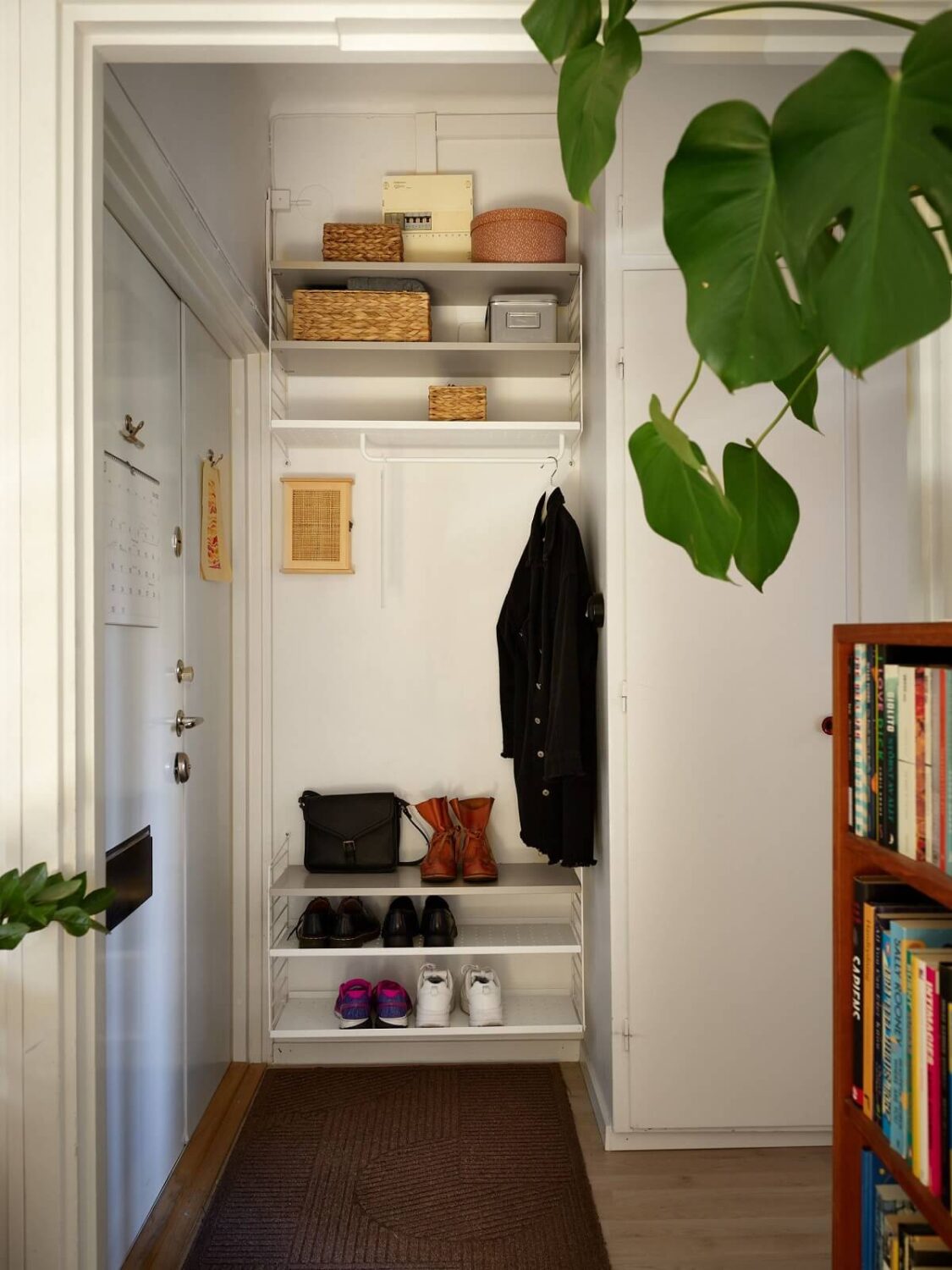 A Swedish Apartment with a Tiny Terracotta Brown Bedroom 16 small hallway with shelves