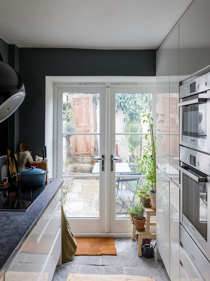 A Charming English Cottage Filled with Historic Character 8 small white kitchen with garden doors