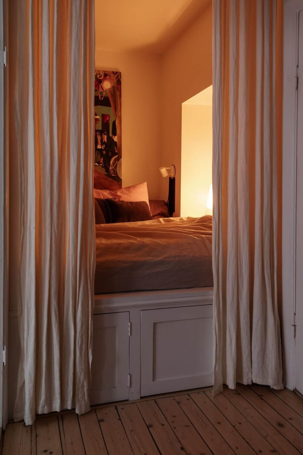 Period Details and Light Rooms in a Scandinavian Apartment 20 snug bedroom with curtains behind the bed