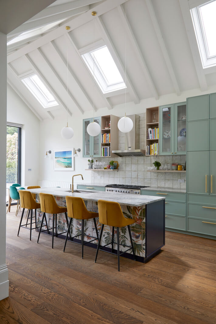 Beautiful Kitchens with Skylights That Add Light and Style 14 spacious kitchen with pitched ceiling and ochre bar stools