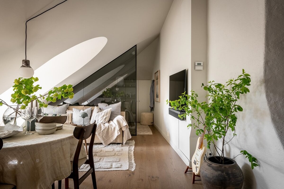 An Attic Studio Apartment with a Glass Room Divider 2 studio apartment slanted ceiling glass room divider