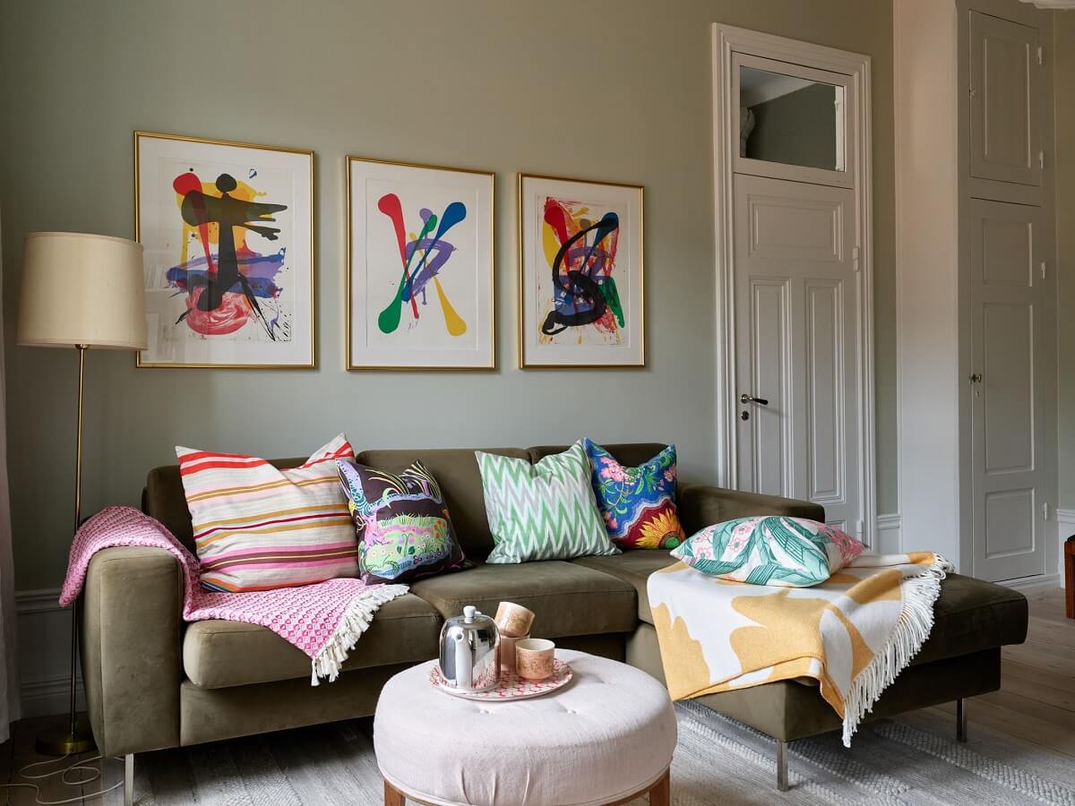 A Green Kitchen in a Gray Family Apartment 17 television room with colorful cushions