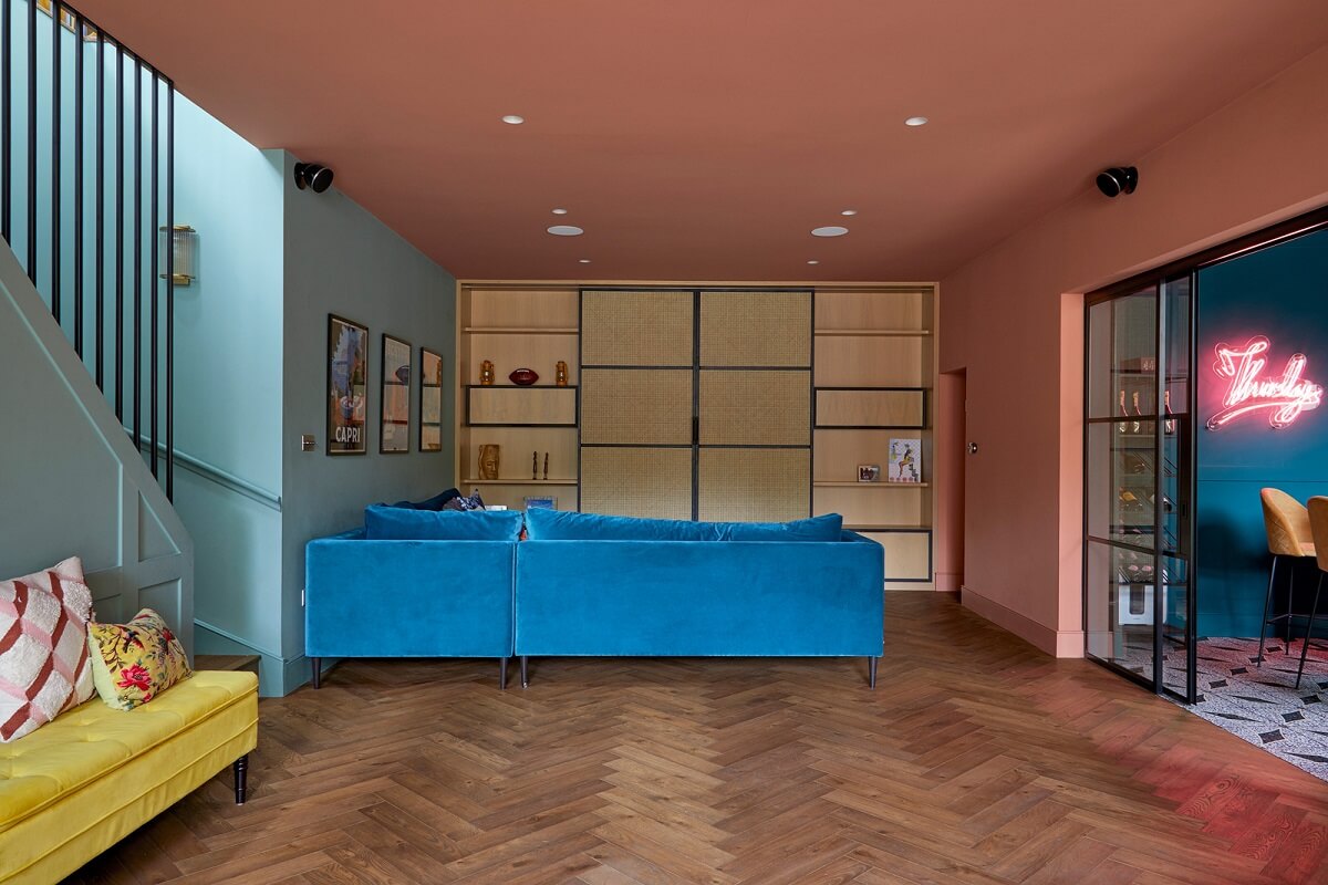 A Colorful London Family Home Renovated by Fraher & Finlay 18 terracotta basement living room with blue sofa