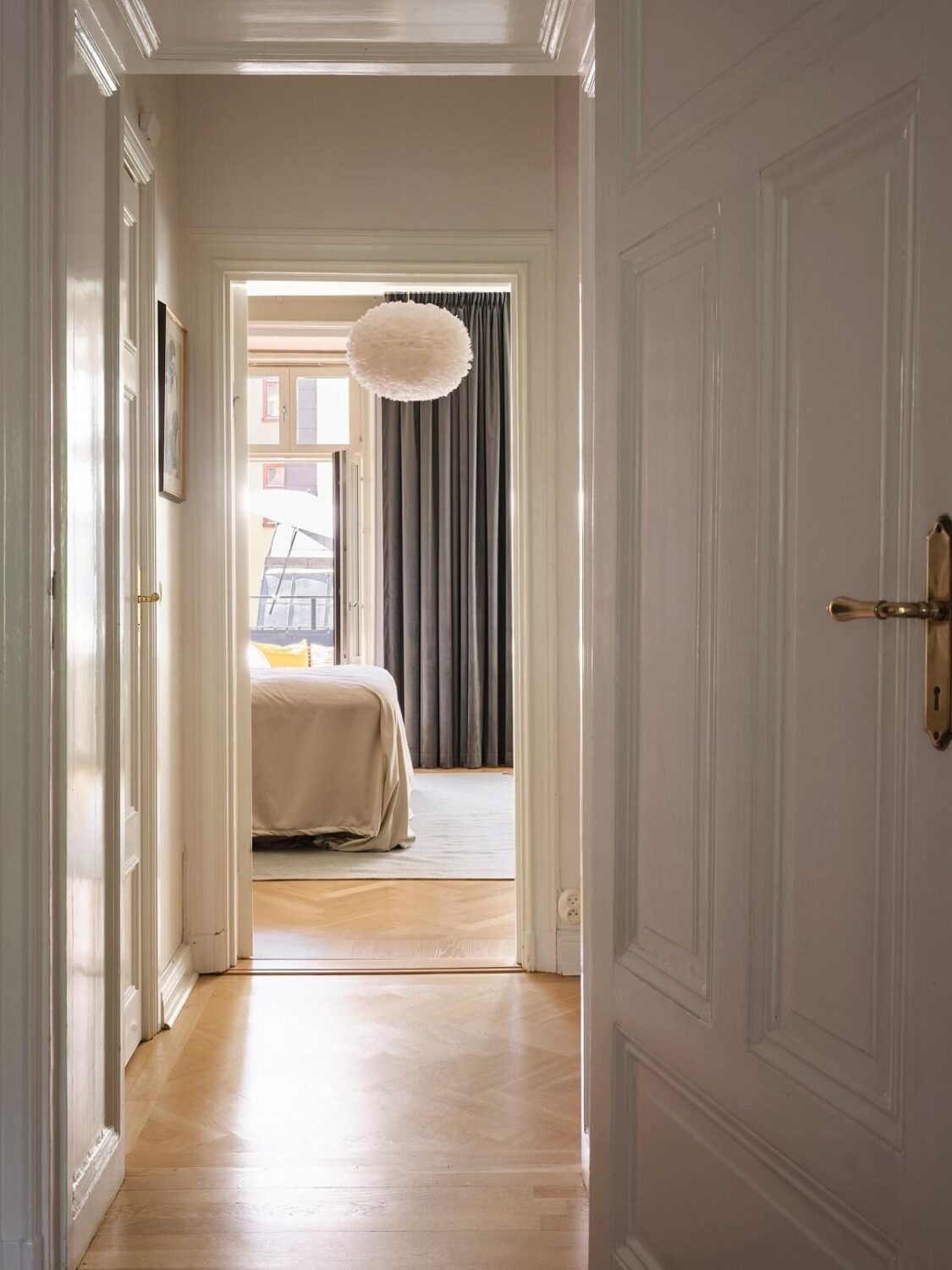 A Classic Stockholm Apartment with Floral Wallpaper 17 view into bedroom