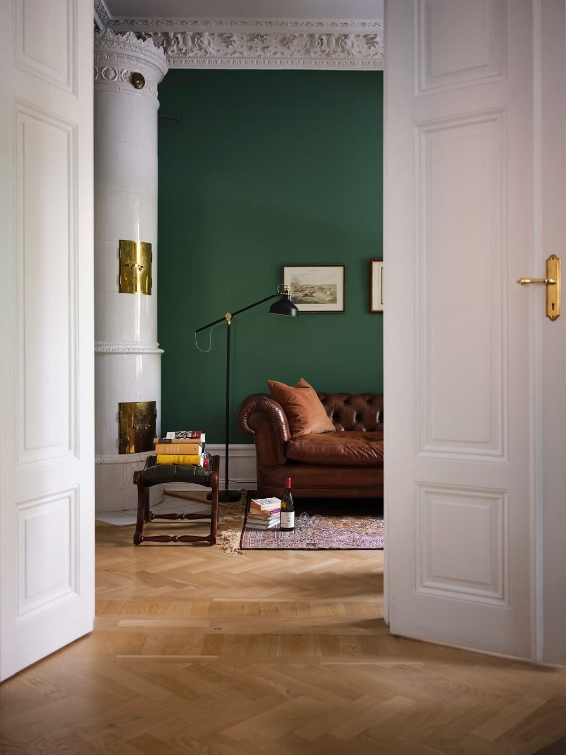 A Classic Stockholm Apartment with Floral Wallpaper 6 view into green home office with fireplace nordroom
