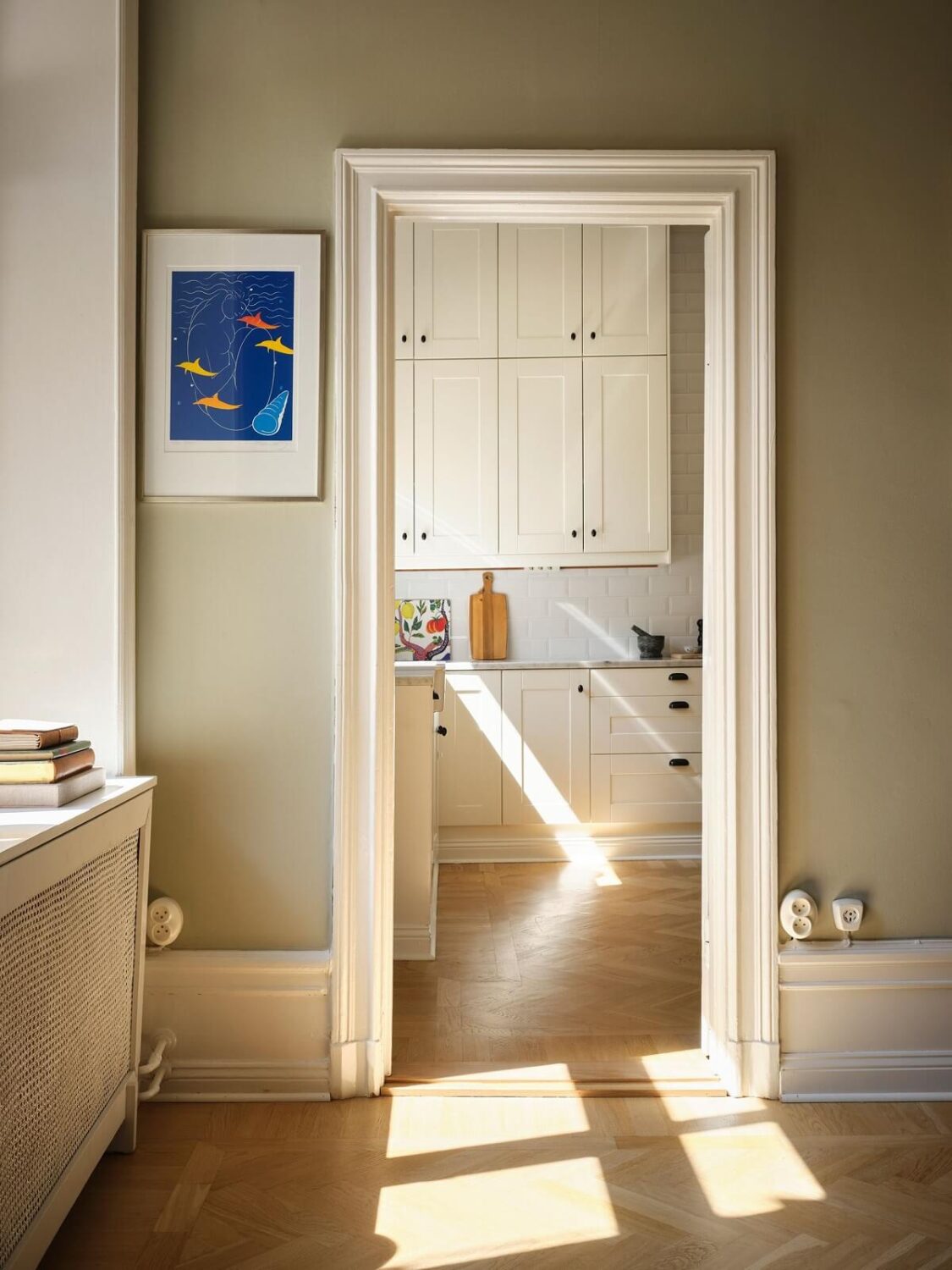 A Classic Stockholm Apartment with Floral Wallpaper 16 view into kitchen with sunlight nordroom