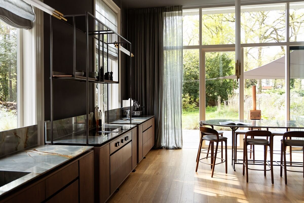 A Warm Atmosphere in a Historic Dutch Villa 10 walnut kitchen and floor to ceiling windows