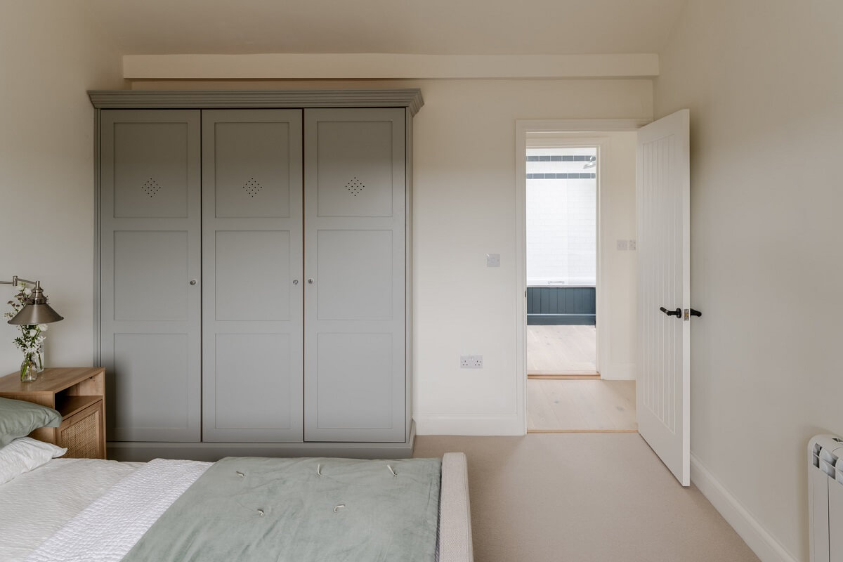 A Modern Barn House in the English Countryside 17 white bedroom with wardrobes