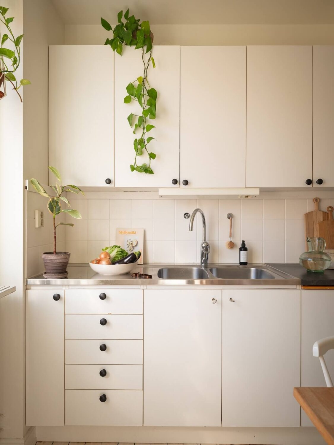 Calm Color Tones in a Light Scandinavian Studio Apartment 10 white kitchen
