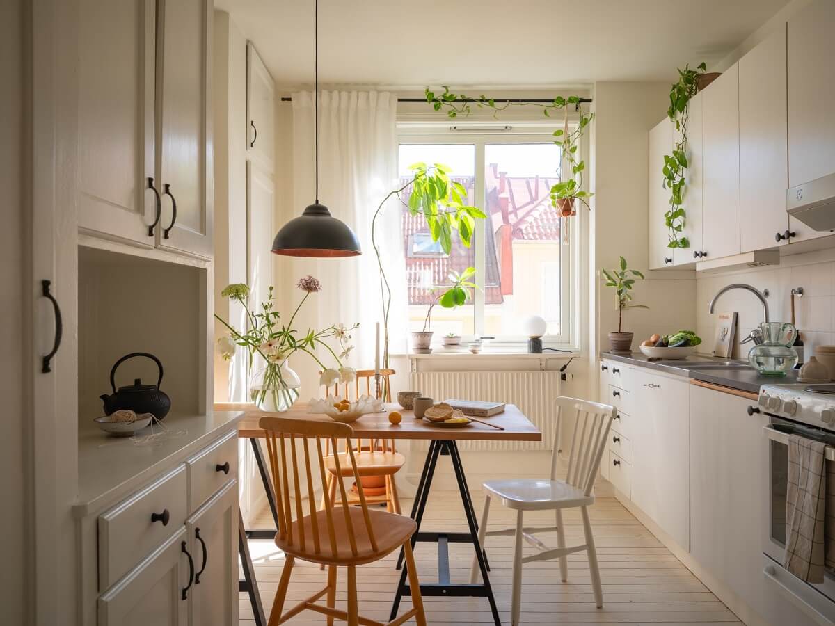 Calm Color Tones in a Light Scandinavian Studio Apartment 8 white kitchen with dining table