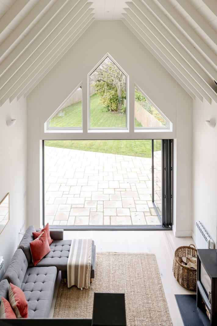A Modern Barn House in the English Countryside 10 white living room pitched ceiling wooden beams nordroom