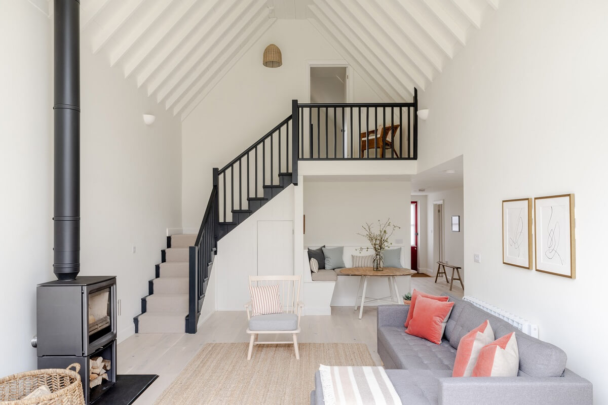 A Modern Barn House in the English Countryside 8 white living space with gray ceiling and pitched ceiling nordroom