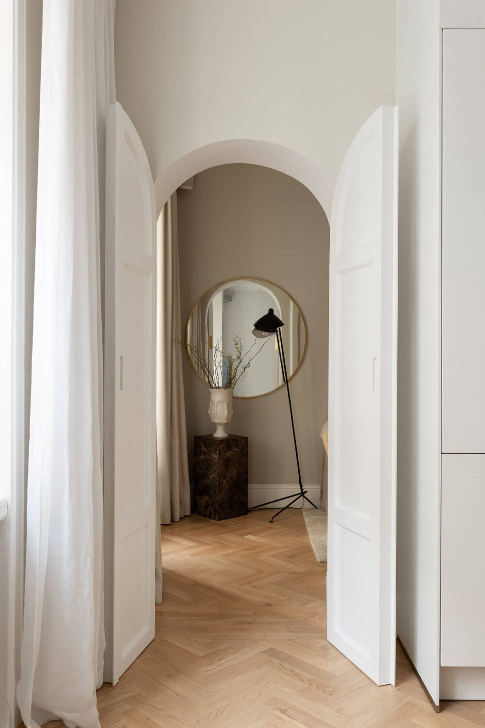 A Classic Look for a Swedish Apartment 9 arched doorway to bedroom