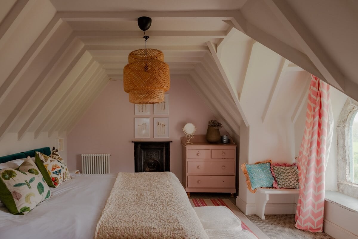 A Charming Gothic-Style Home with Original Details 27 attic bedroom with pink wall and dormer window nordroom