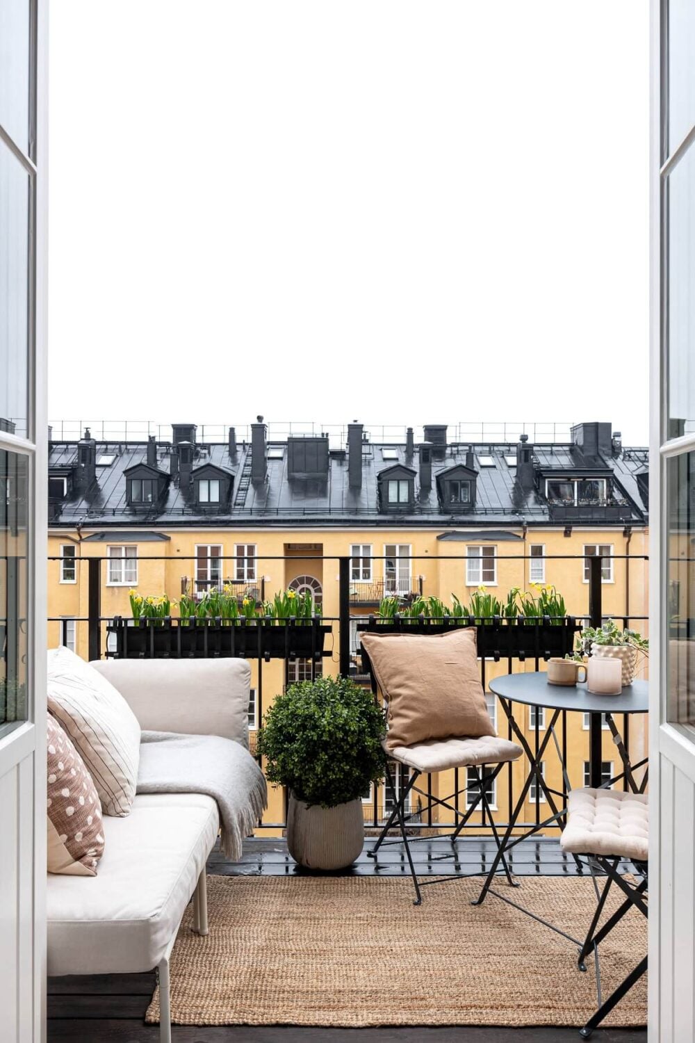 A Stylish Renovated Stockholm Apartment with Built-In Storage 15 balcony with lounge sofa and table nordroom