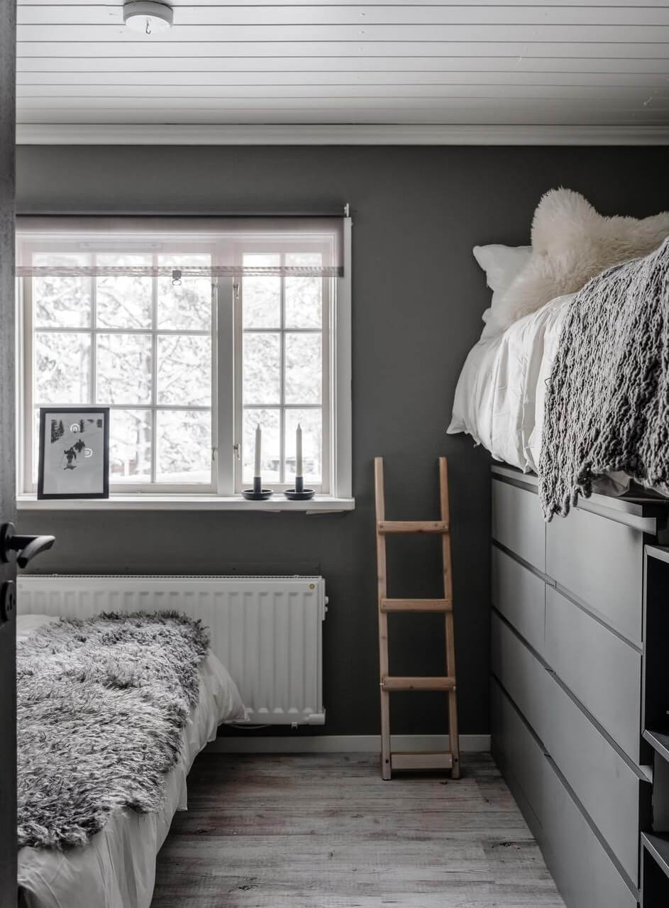 A Gray Swedish Log House Decorated for Christmas 13 bed with drawers underneath