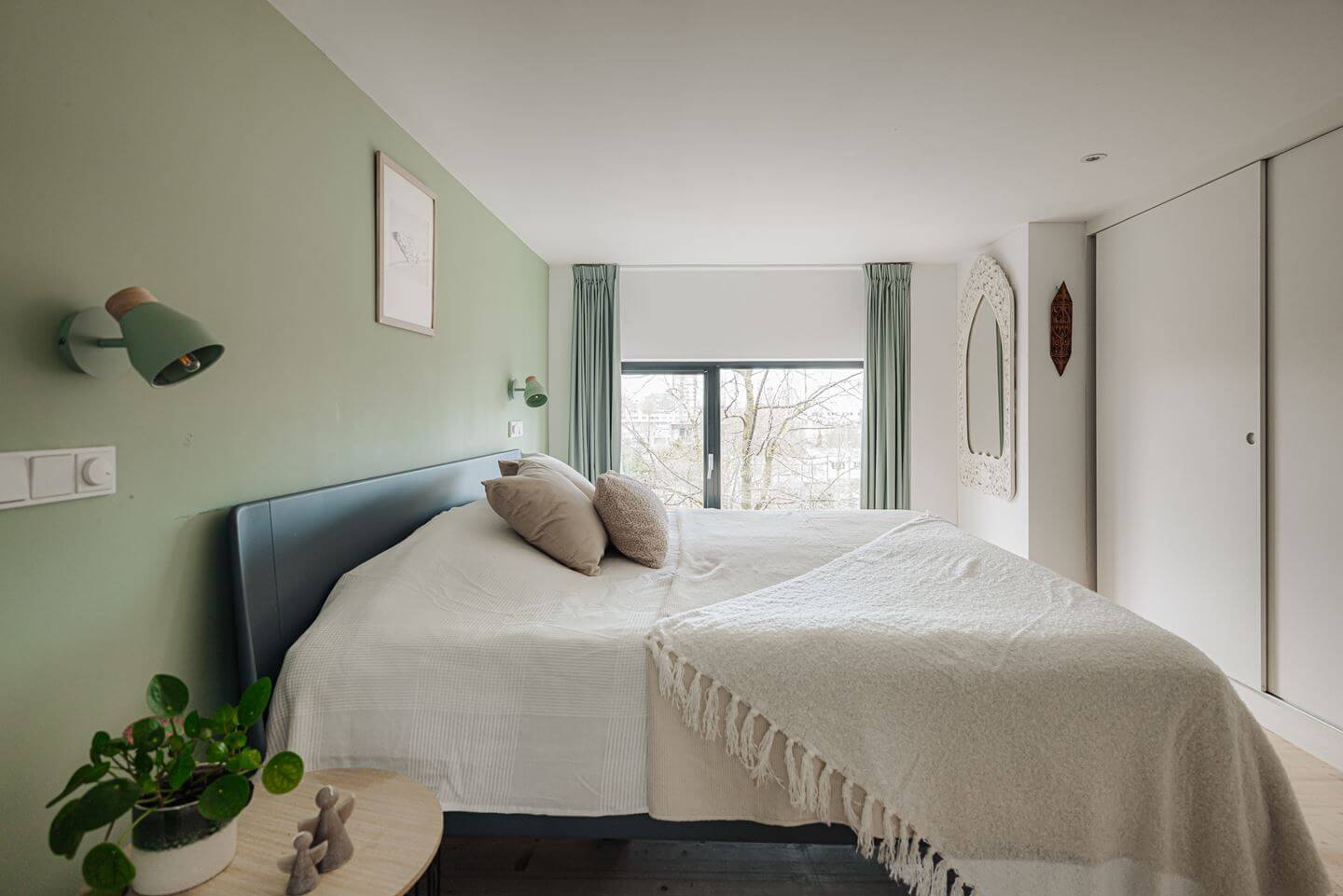 A Modern Loft-Style School Conversion in Amsterdam 17 bedroom light green accent wall