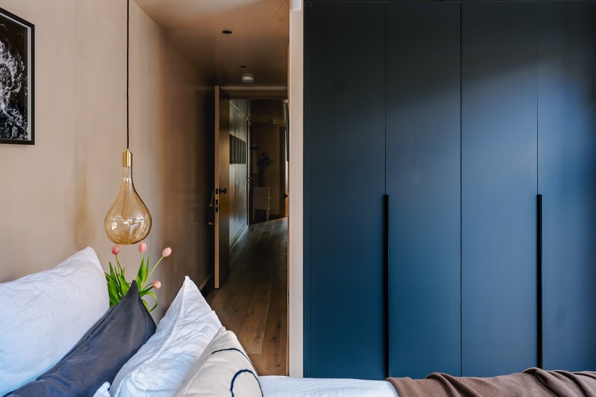 Warm Color Tones in a London Apartment with a Garden 11 bedroom with blue built in wardrobes