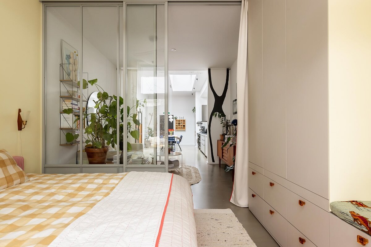 A Unique Basement Apartment in Stockholm 11 bedroom with custom wardrobes and pale yellow walls nordroom