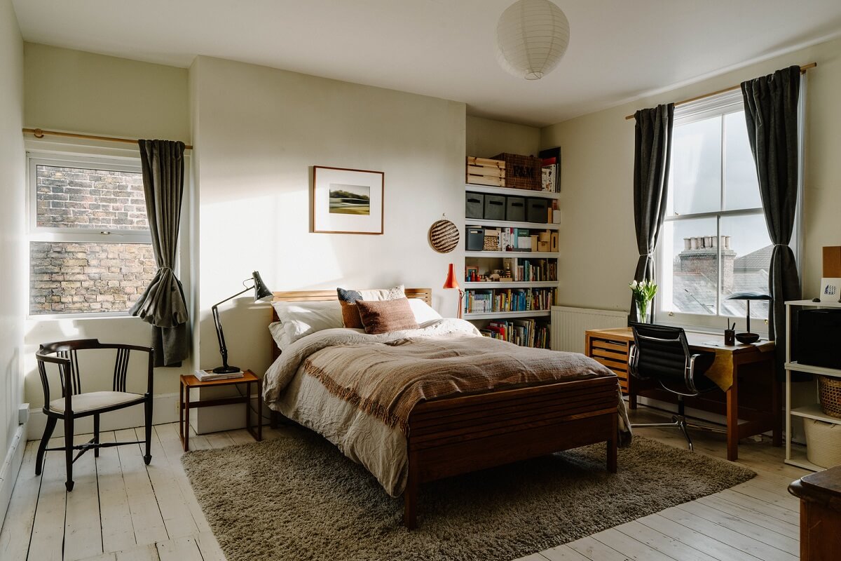 Neutral Tones and Original Features in an English Townhouse 11 bedroom with desk and bookshelves
