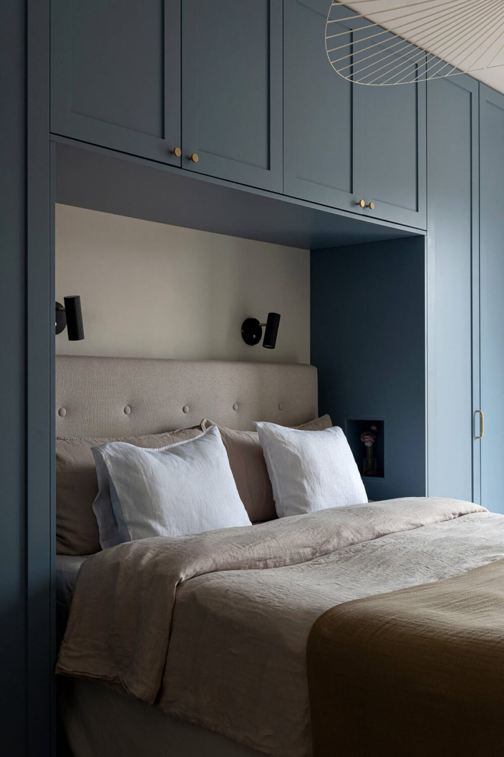 A Stylish Renovated Stockholm Apartment with Built-In Storage 12 bedroom with dusty blue built in wardrobes around the bed nordroom