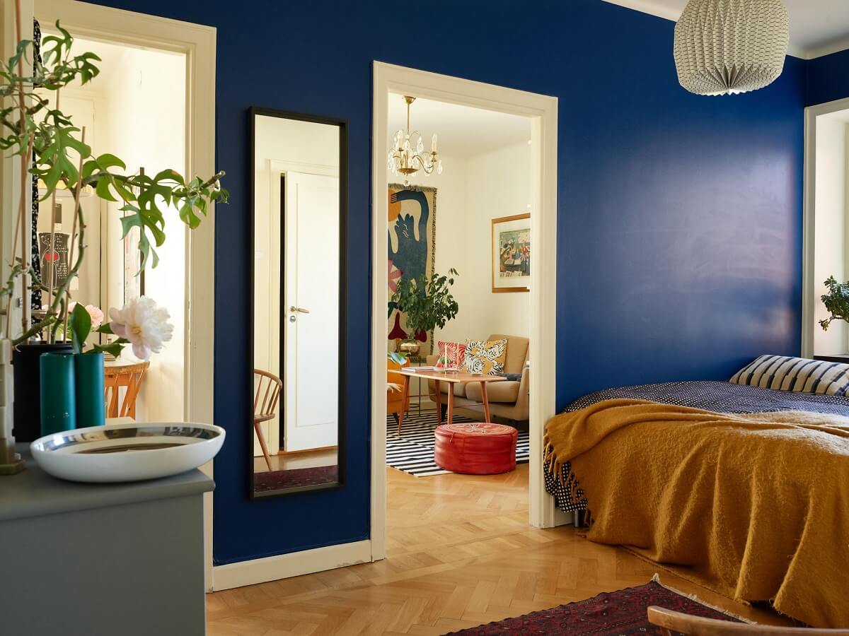 Valspar Color of the Year 2025: Encore 12 bedroom with vibrant blue walls and yellow throw nordroom