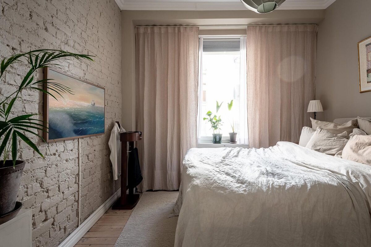 A Turn of the Century Apartment with a Green Kitchen 17 bedroom with white painted brick wall