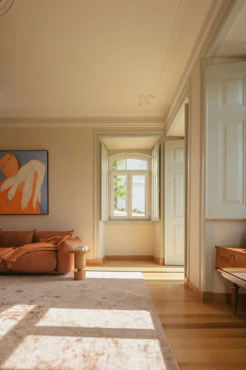 Color Touches in a Design Apartment in a Historic Villa 3 beige walls large living room wooden floor window shutters nordroom