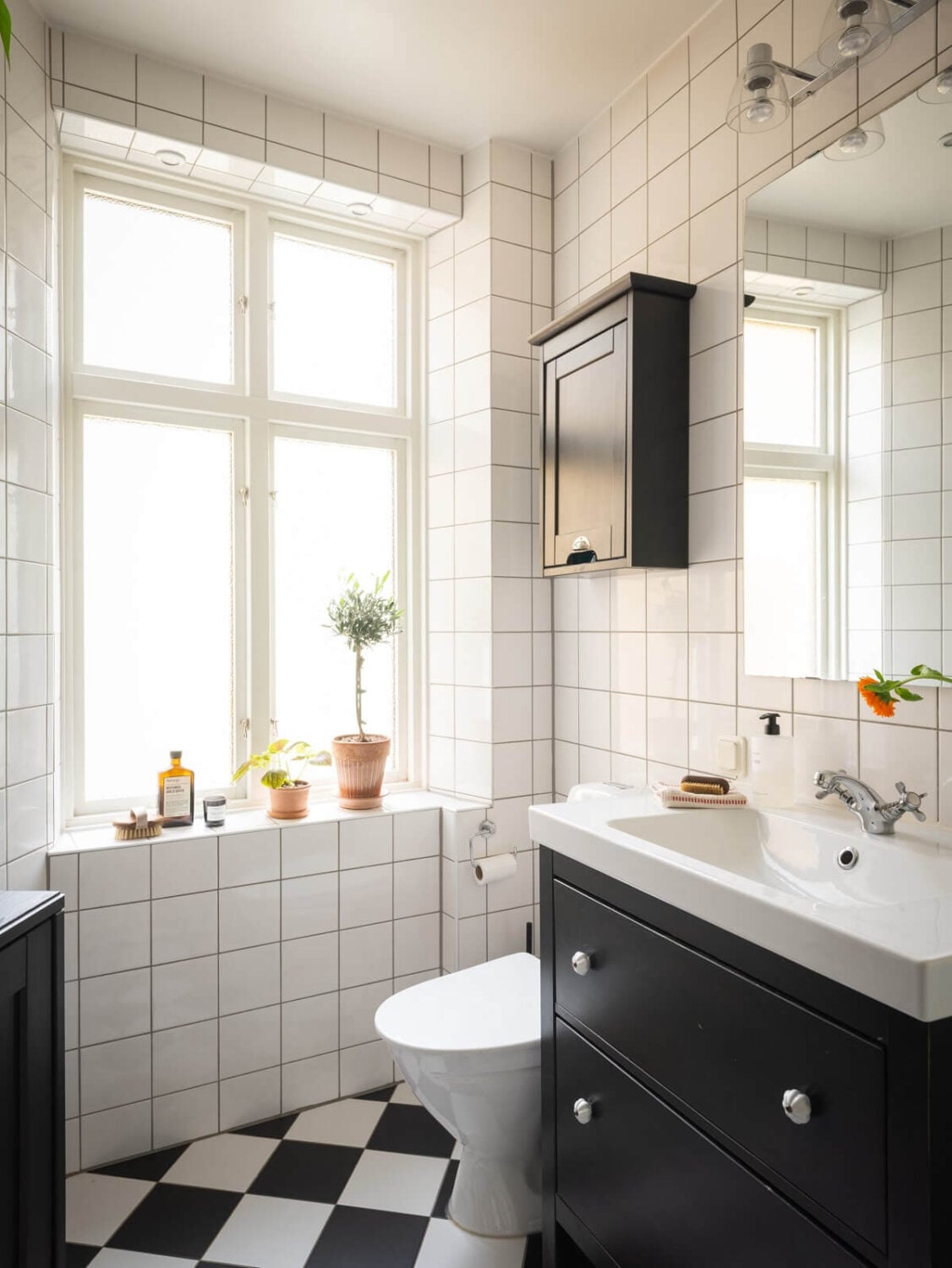 Original Details in a Light-Filled Swedish Apartment 14 black and white bathroom with checkerboard floor