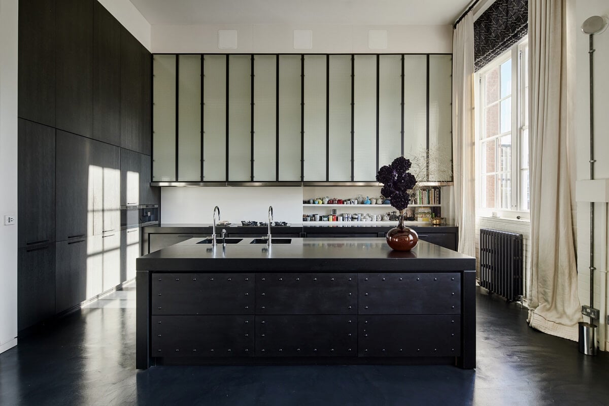 A Monochrome London Loft Filled with Art 13 black kitchen with floor to ceiling cabinets monochrome loft apartment london nordroom