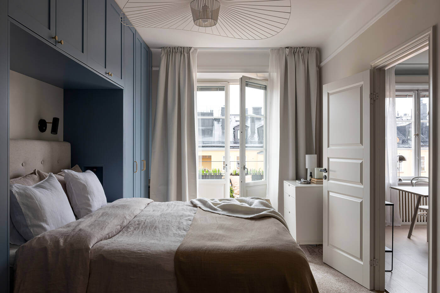 A Stylish Renovated Stockholm Apartment with Built-In Storage 14 blue wardrobes in bedroom