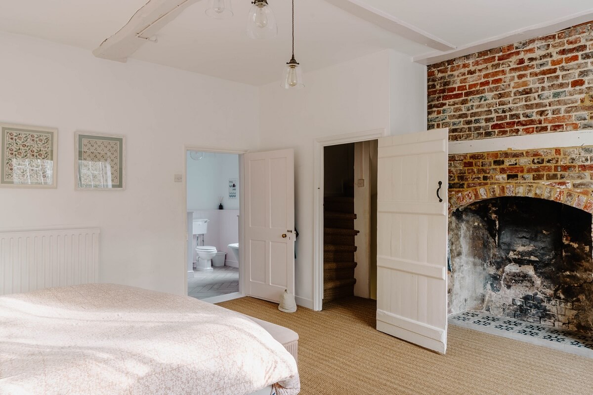 An 18th-Century Historic House with an Amazing Kitchen 17 brick fireplace in bedroom