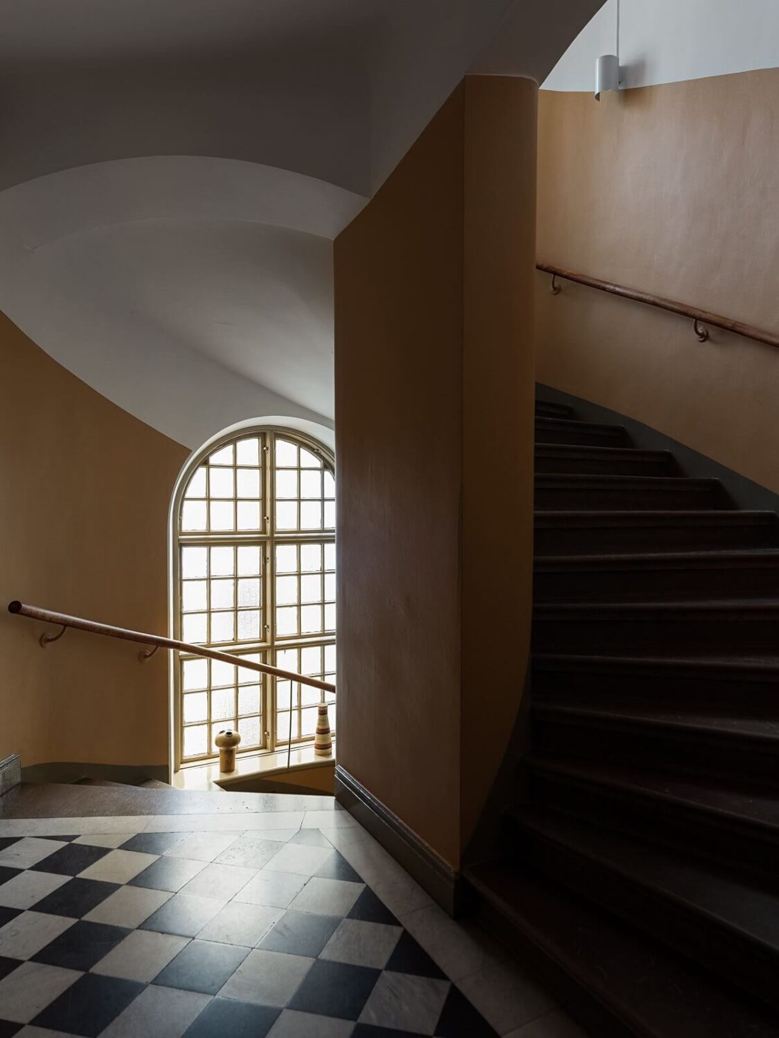 A Gray Stockholm Apartment with a Black Kitchen 21 central hall with checkerboard floor and spiral staircase nordroom