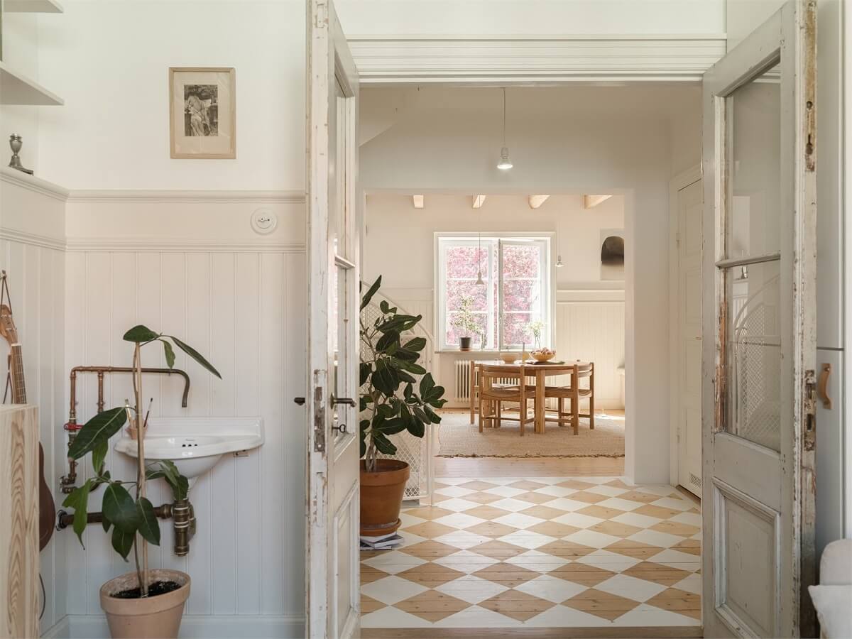 Wooden Details in a Light Duplex Apartment in Sweden 3 checkerboard floor hallway