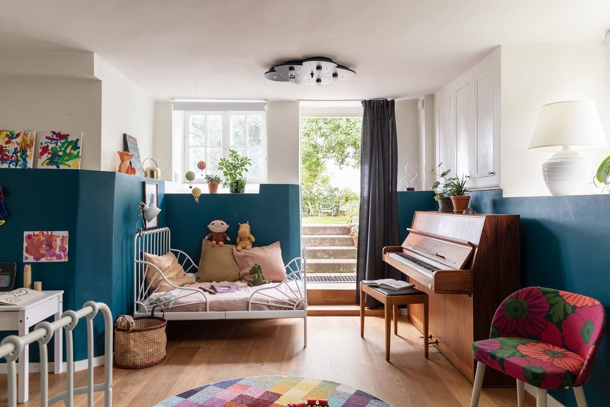 A Swedish Duplex with a Unique Wood and Pastel Colored Kitchen 20 children bedroom with half painted teal wall nordroom