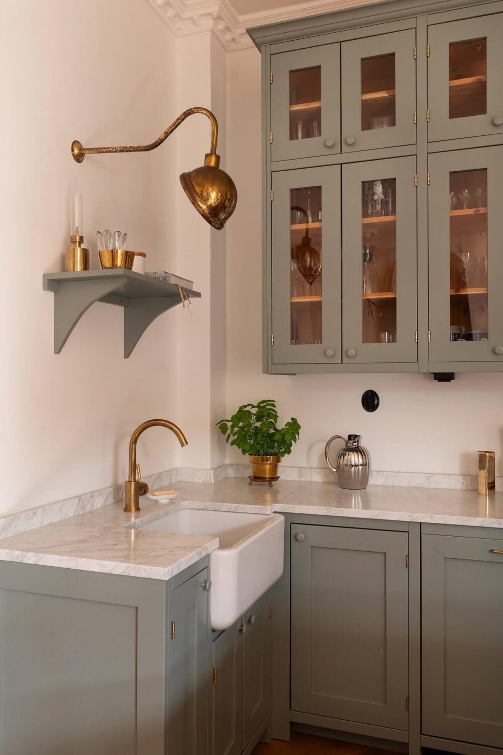 An Elegant Turn-of-the-Century Apartment in Stockholm 2 classic gray kitchen with butler sink brass fittings open and closed cabinets nordroom