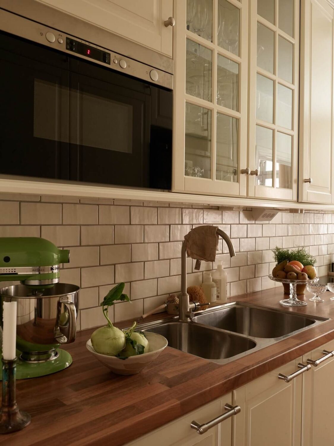 Warm Tones and a Blue Hallway in a Stockholm Apartment 11 classic kitchen with subway tiles