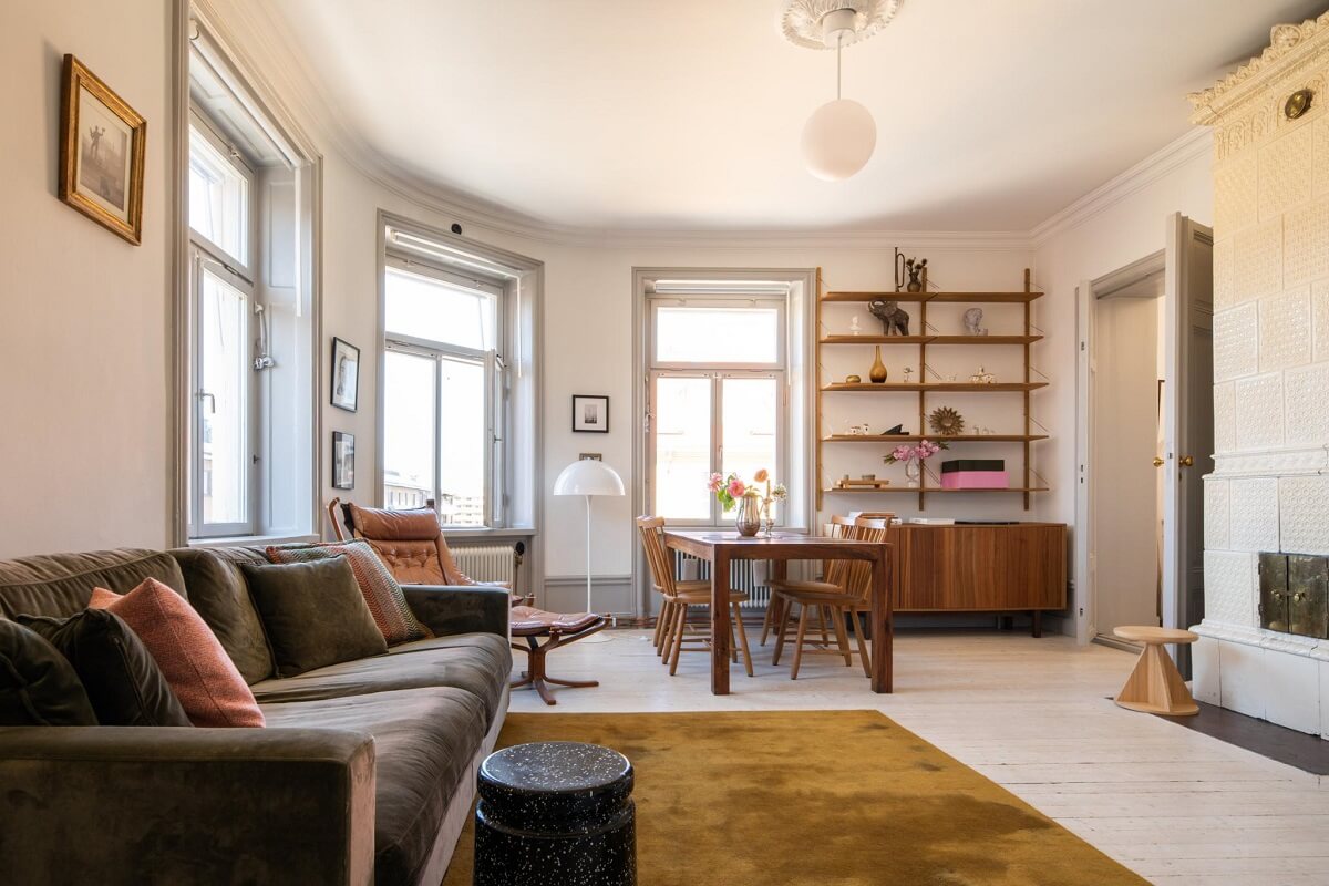 A Corner Apartment with an Industrial Style Kitchen 10 corner living room with large windows and ochre rug