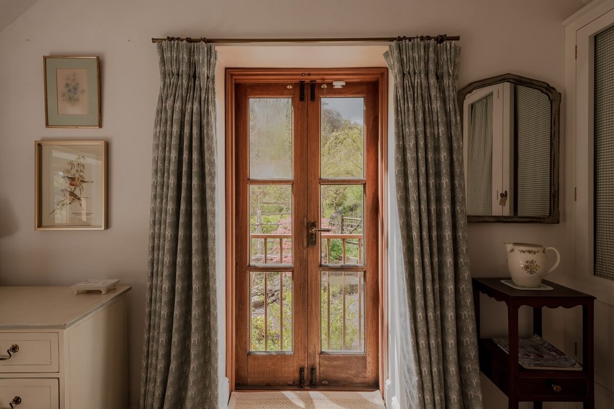 Ochre Yellow and Green Tones in a Cozy Welsh Cottage 18 cottage bedroom french window