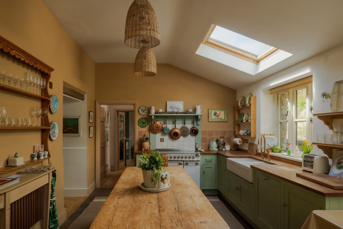 Ochre Yellow and Green Tones in a Cozy Welsh Cottage 1 cottage kitchen with skylight and farmhouse table nordroom