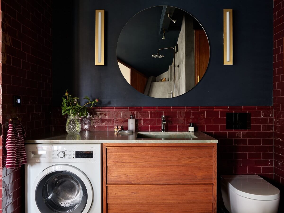 A Stunning Bathroom in a Duplex Apartment in Stockholm 24 dark bathroom with red tiles and round mirror