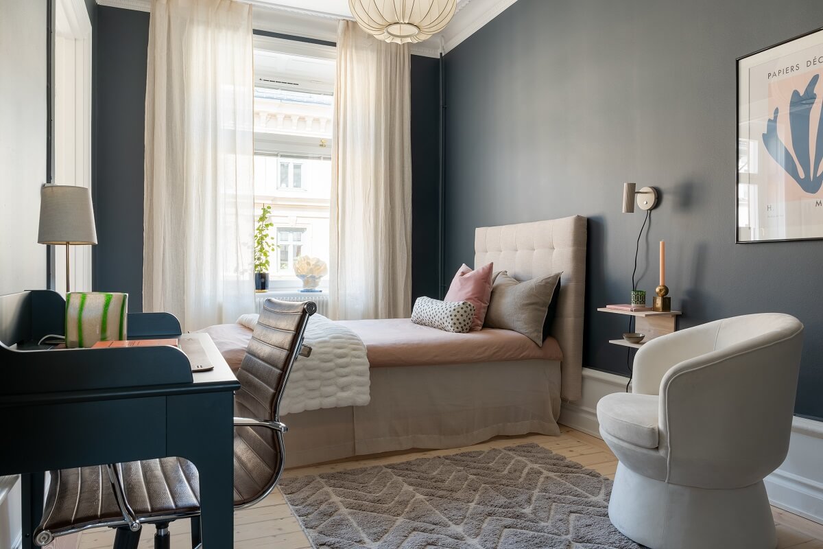 A Light Renovated Apartment in Stockholm 16 dark bedroom with chair
