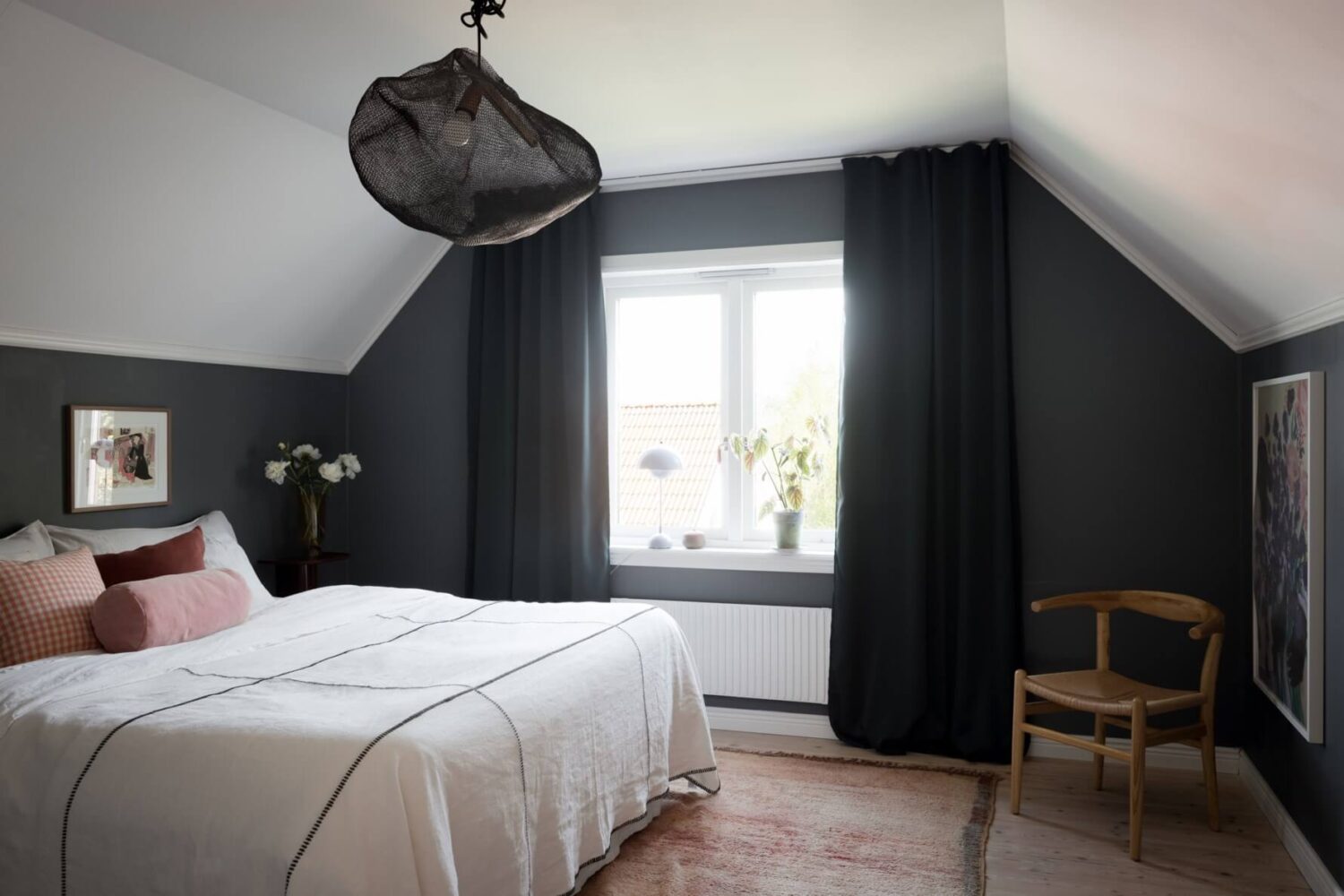 A Pink Swedish House with a Lovely Garden 17 dark gray bedroom with slanted ceilings
