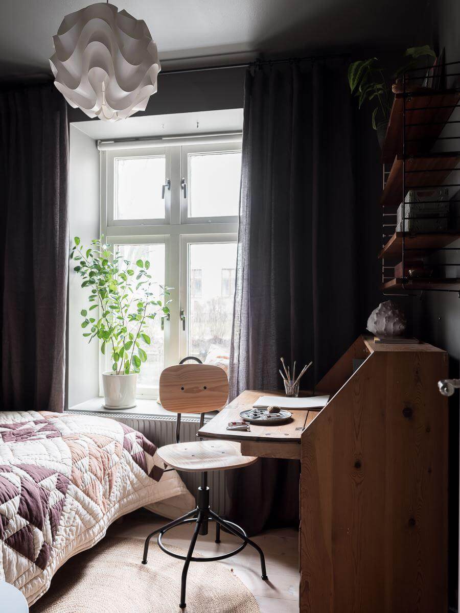 A Light Two Bedroom Apartment in Gothenburg 24 dark gray bedroom with vintage desk nordroom