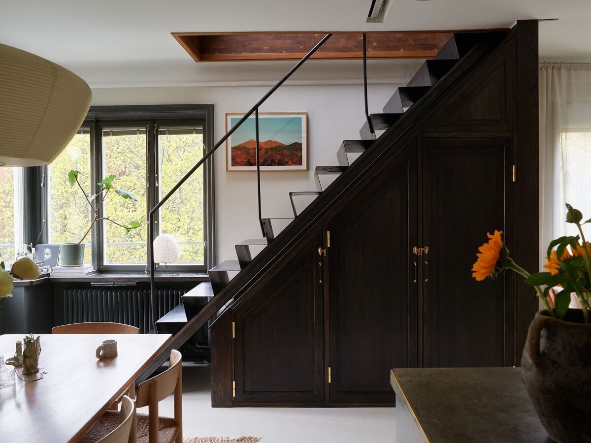 A Stunning Bathroom in a Duplex Apartment in Stockholm 13 dark staircase with storage
