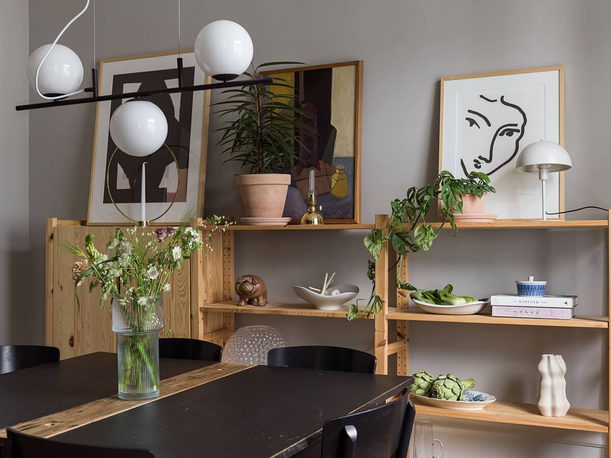 A Gray Stockholm Apartment with a Black Kitchen 10 dining room with wooden shelves and cabinet