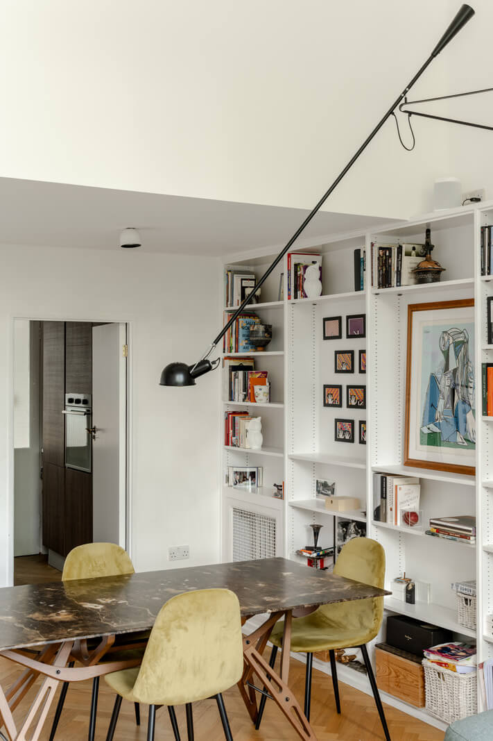 High Ceilings in a Light London Apartment 3 dining table with bookcases nordroom