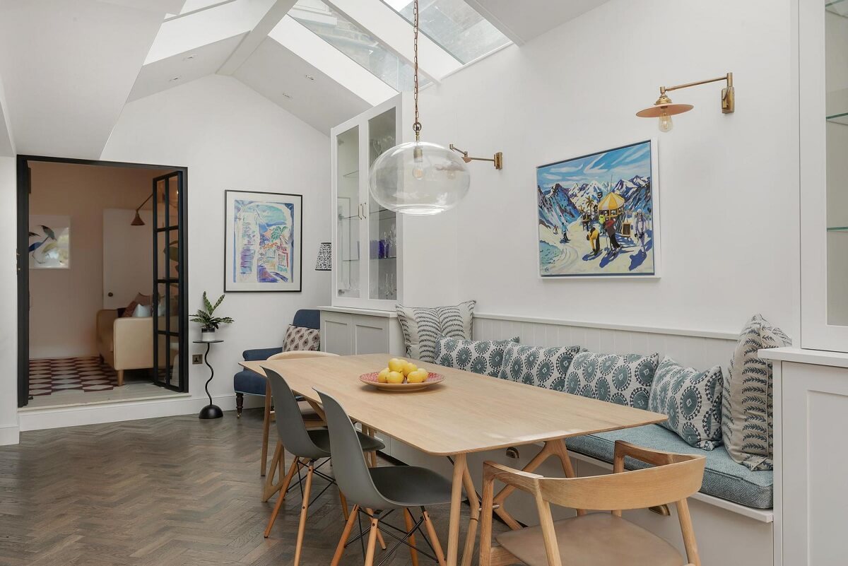 A Victorian House with a Blue deVOL Kitchen 6 dining table with built in bench and skylights