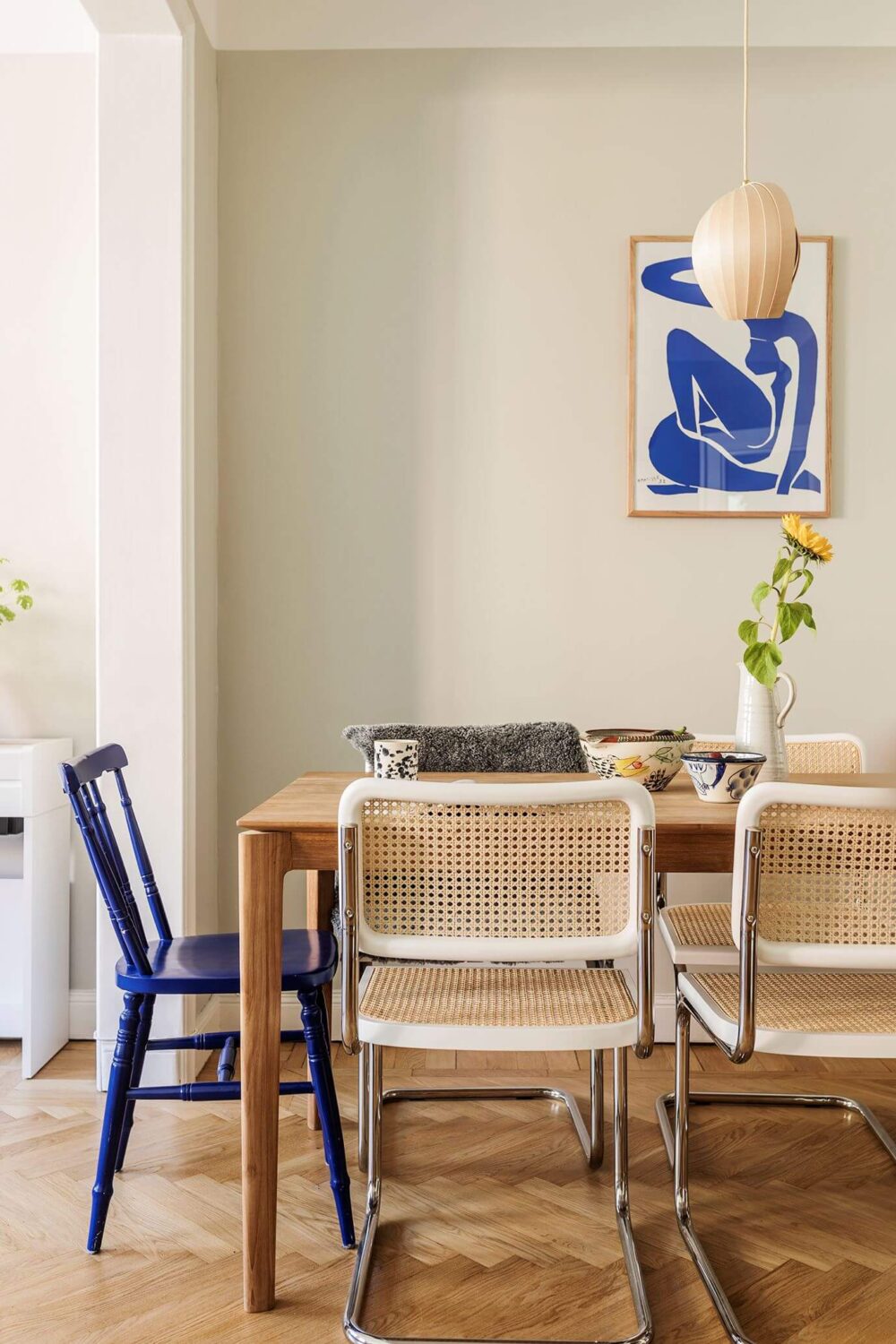 A Small Renovated 1920s Apartment in Stockholm 5 dining table with cobalt blue chair