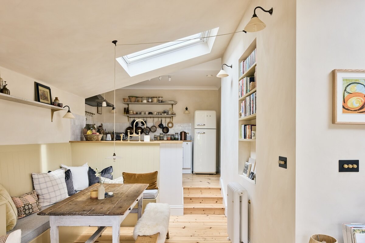 A Light Garden Apartment in London's Poet's Corner 8 dinng area with bench in open plan living space with pitched ceiling